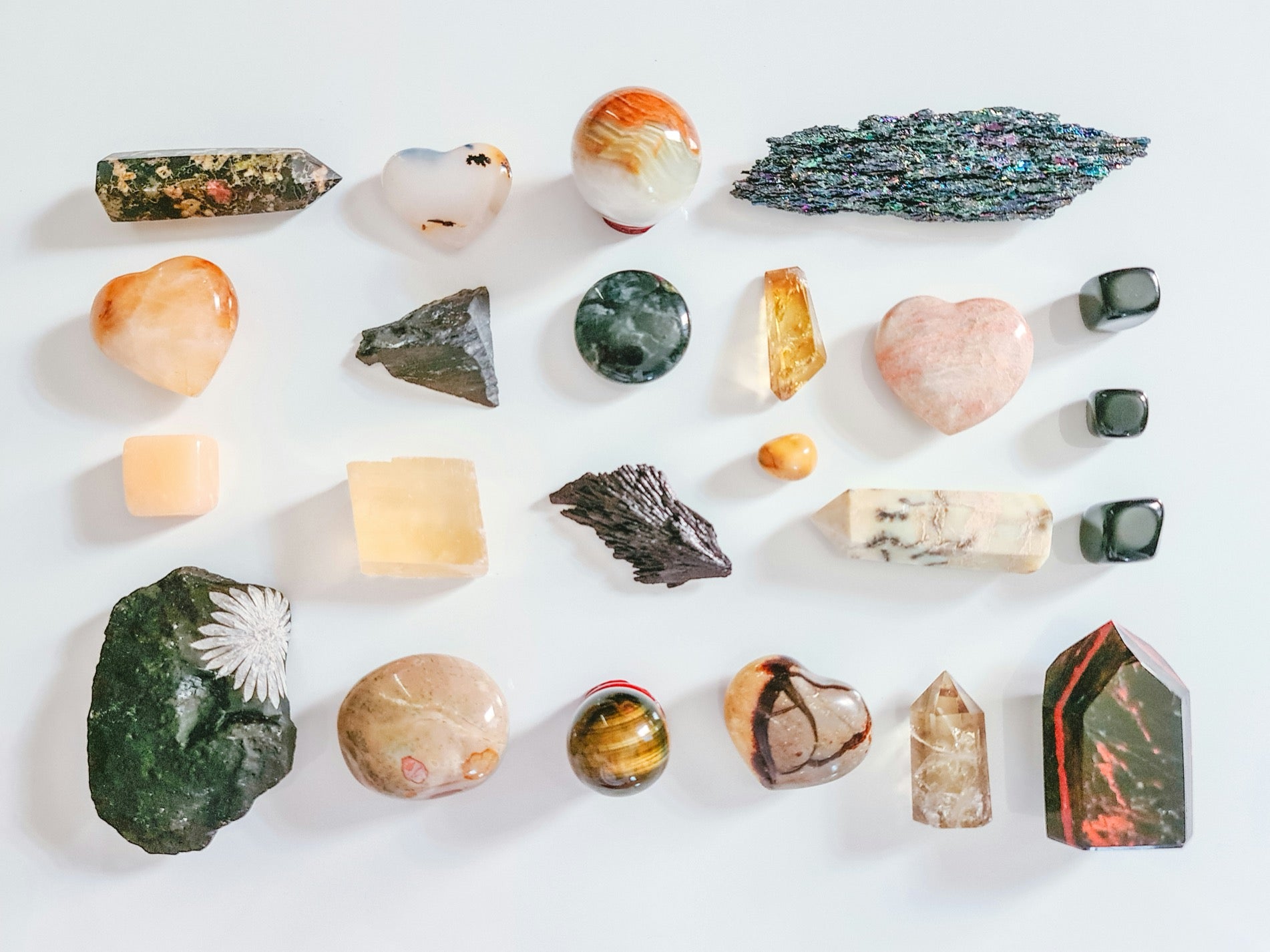 Collection of various crystals and stones on a white background