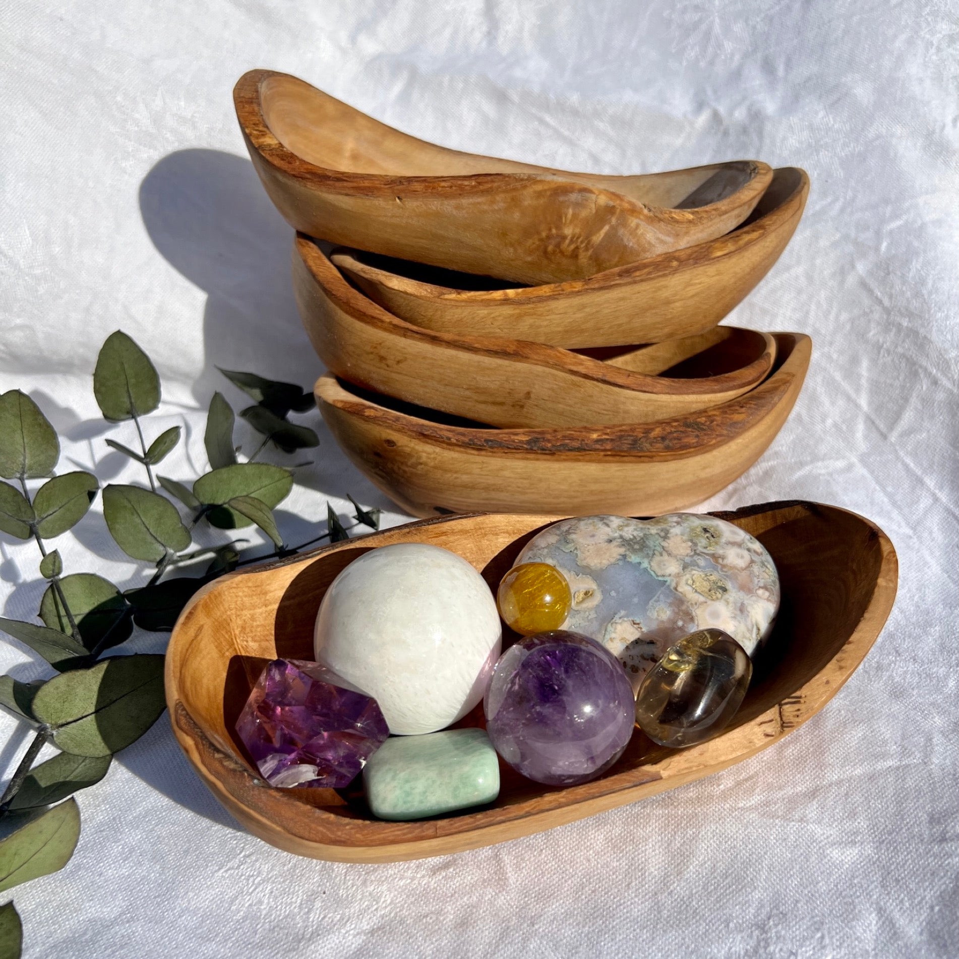 Green chrysoprase healing crystal bracelets in brass dish with Palo Santo