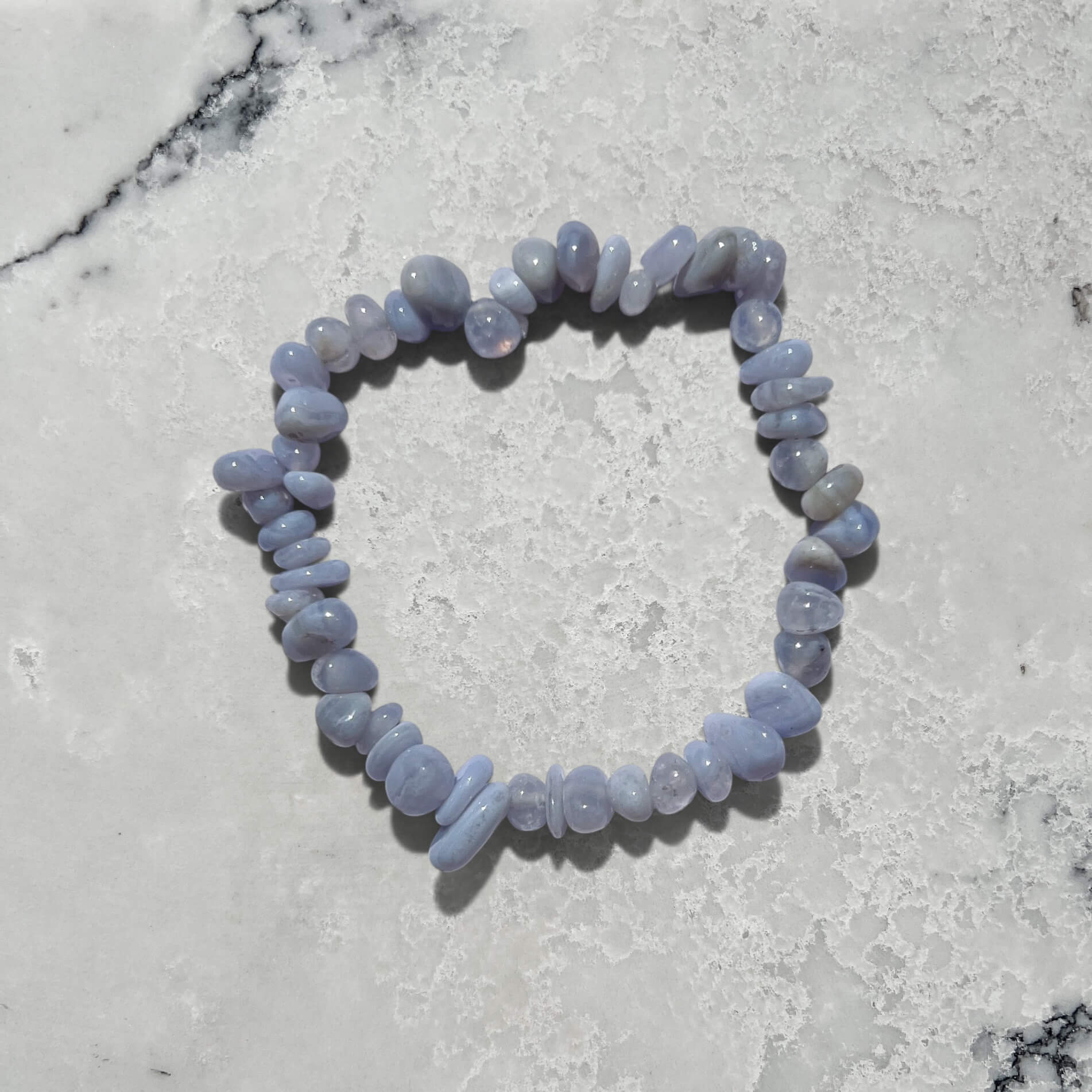 Blue Agate crystal chip gemstone bracelet on a marble surface