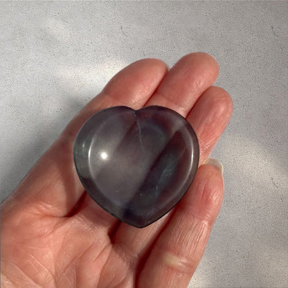 Rock + Realm Crystals blue fluorite heart worry stone, polished smooth held on open hand