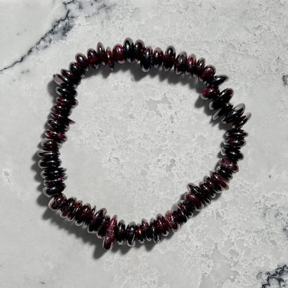 Garnet beaded bracelet on a marble surface