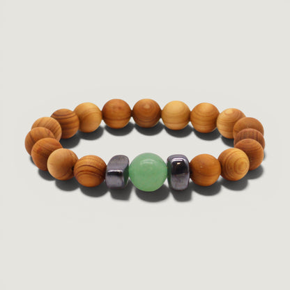 Cedar wood beaded bracelet with green aventurine and metallic black hematite beads on a plain light grey backdrop