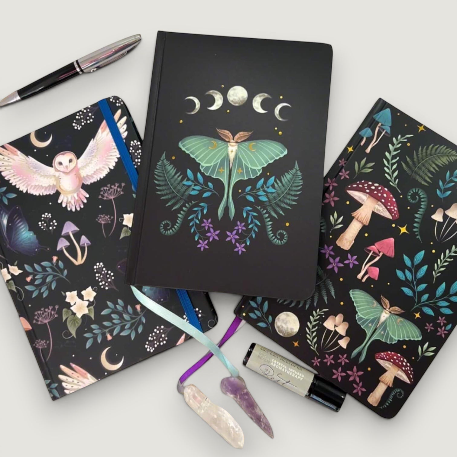Rock + Realm Crystals Dark Forest A5 notebook with moon phases and luna moth design. Features celestial and botanical motifs.