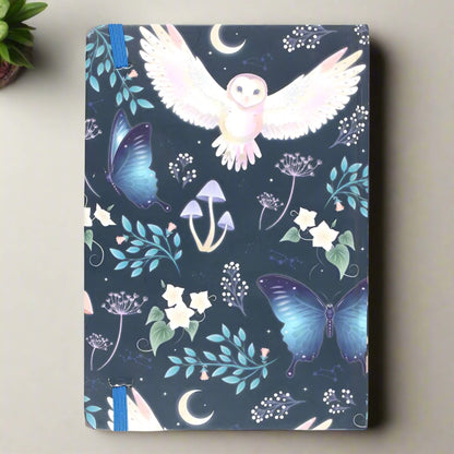 Rock + Realm Crystals blue mystical owl journal with butterflies, mushrooms, moons, and constellations.