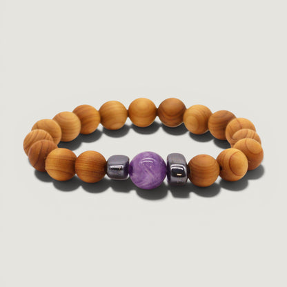 Cedar wood beaded bracelet with purple amethyst and metallic looking hematite beads on a light grey background