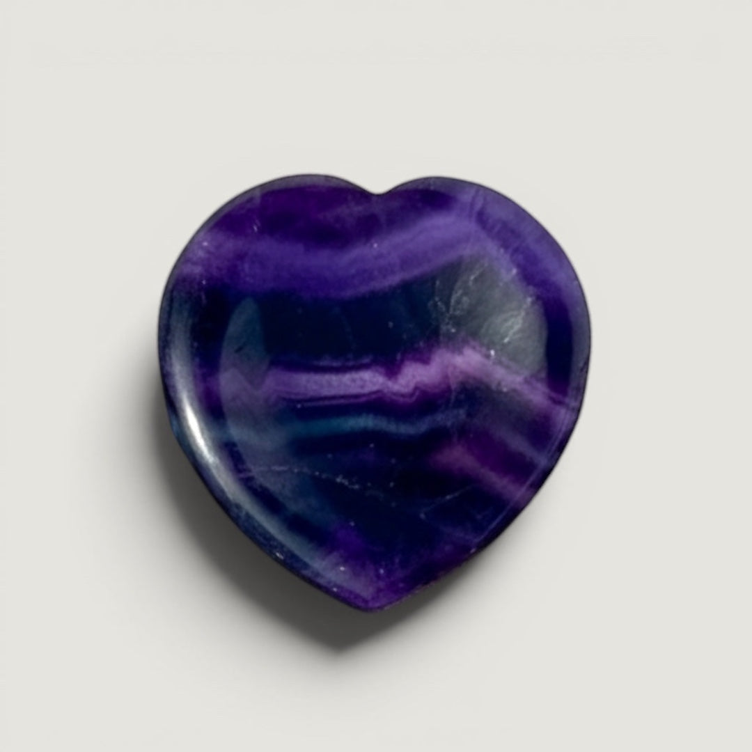 Rock + Realm Crystals dark purple fluorite heart worry stone with unique banding. Polished smooth for a calming touch.