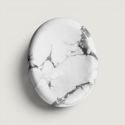 Rock + Realm Crystals polished white and grey marbled oval Howlite crystal worry stone with thumb indentation.