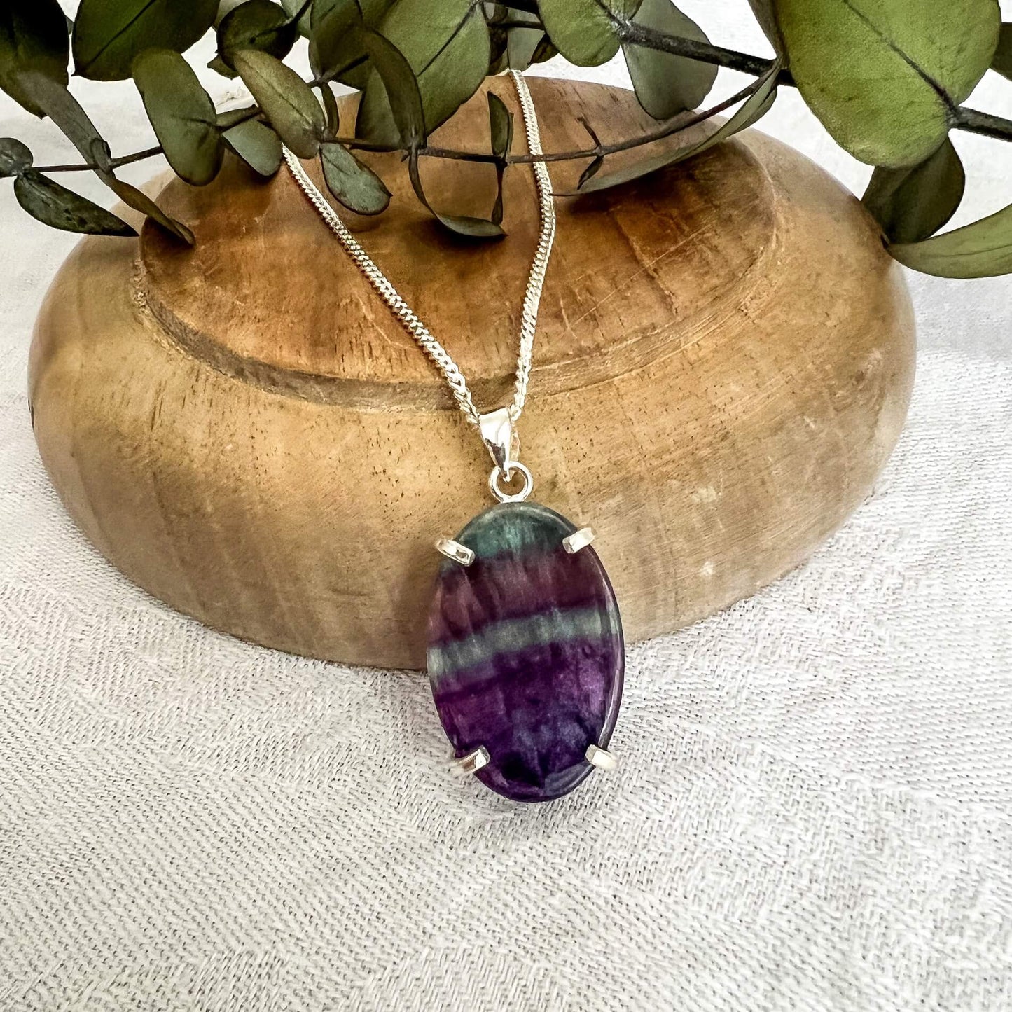 Dark purple and bright blue fluorite crystal oval pendant on a silver chain