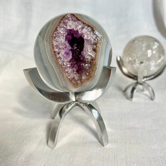 Aluminium Claw Crystal Display Stand with a Rock + Realm Amethyst Geode Sphere held within it