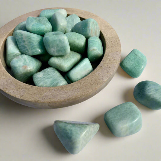 Small wooden dish filled with turquoise coloured amazonite crystal tumblestones