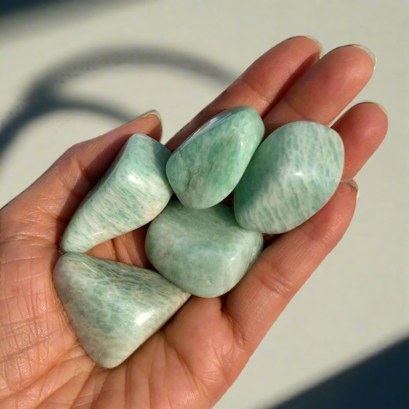 Handful of turquoise coloured amazonite crystal tumblestones