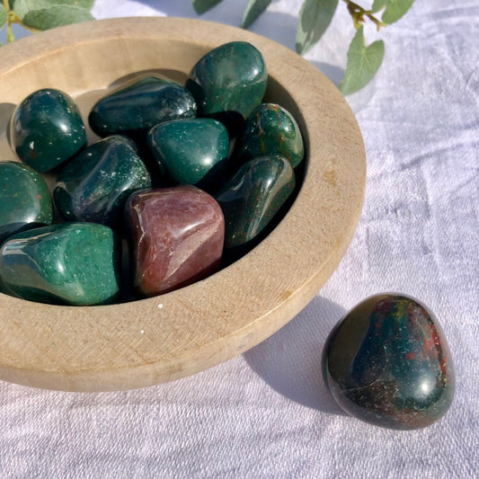 Green and Red Bloodstone crystal pebbles in wooden dish