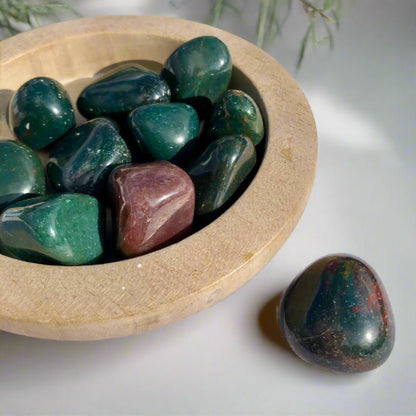 Green and Red Bloodstone crystal pebbles in wooden dish