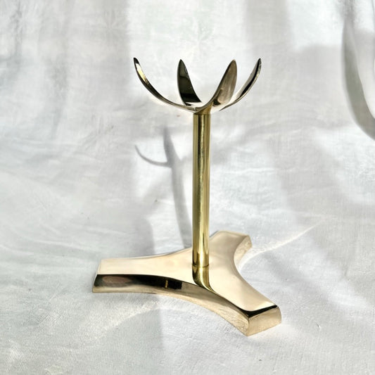 A large and tall brass crystal display stand