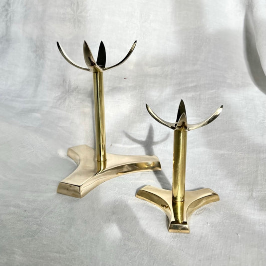 A large and tall brass crystal display stand stood next to a small brass display stand