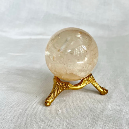 Gold vintage style small crystal sphere holder with a honey optical calcite sphere on top
