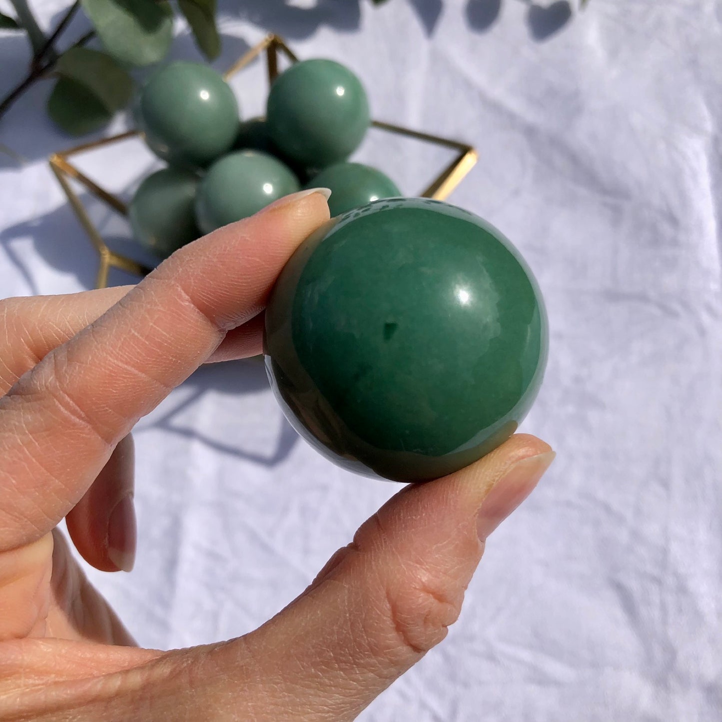 Close up of green aventurine healing crystal spheres for home decor or wellbeing practices