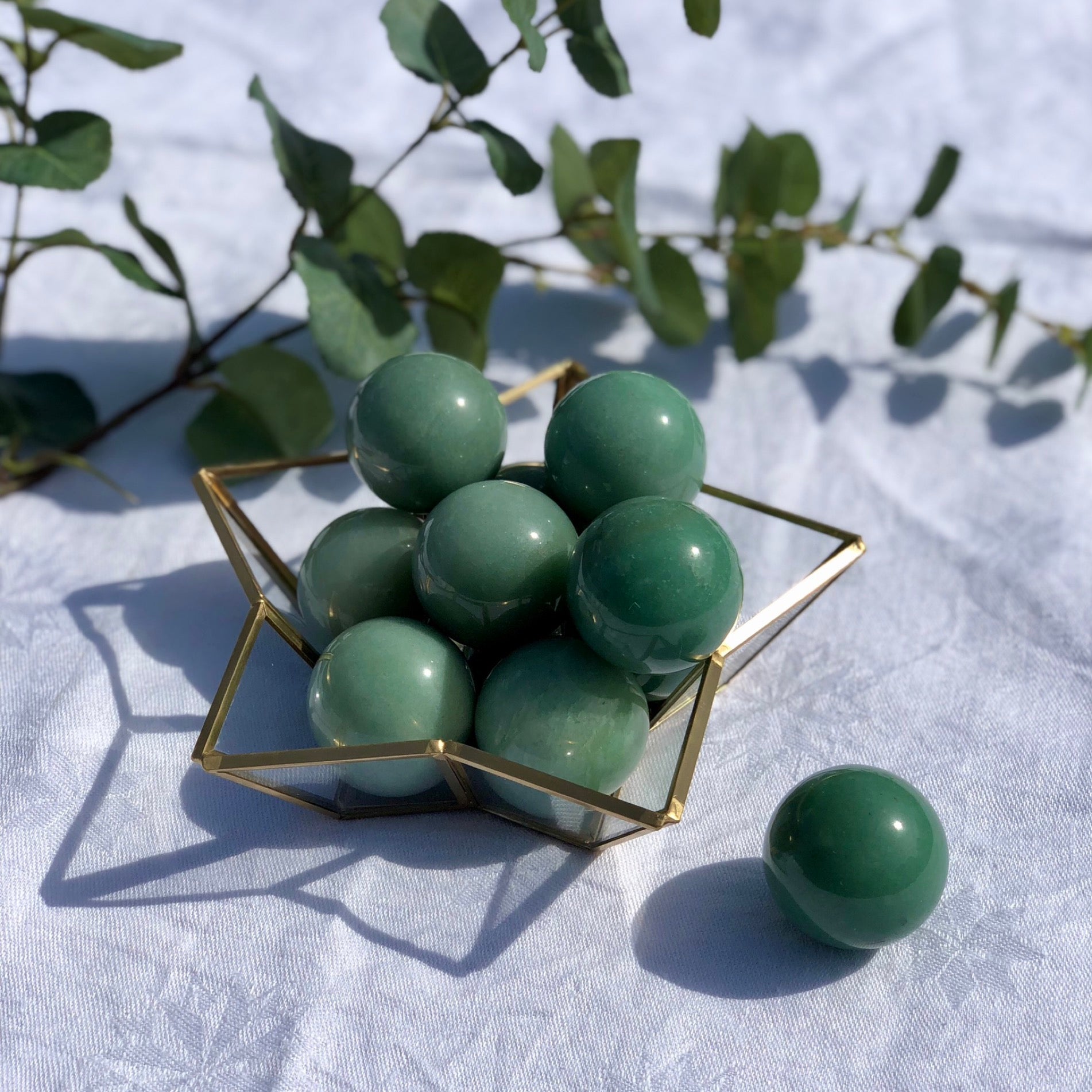 Close up of green aventurine healing crystal spheres for home decor or wellbeing practices
