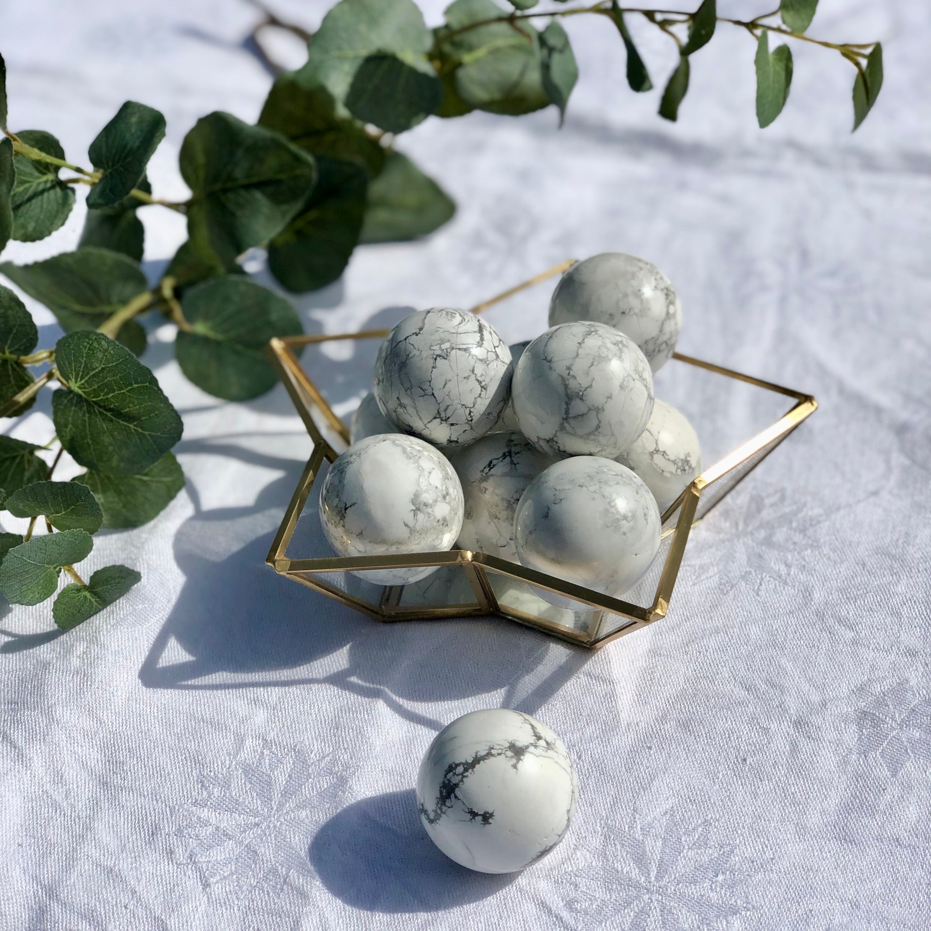 Star dish full of white and grey Howlite spheres
