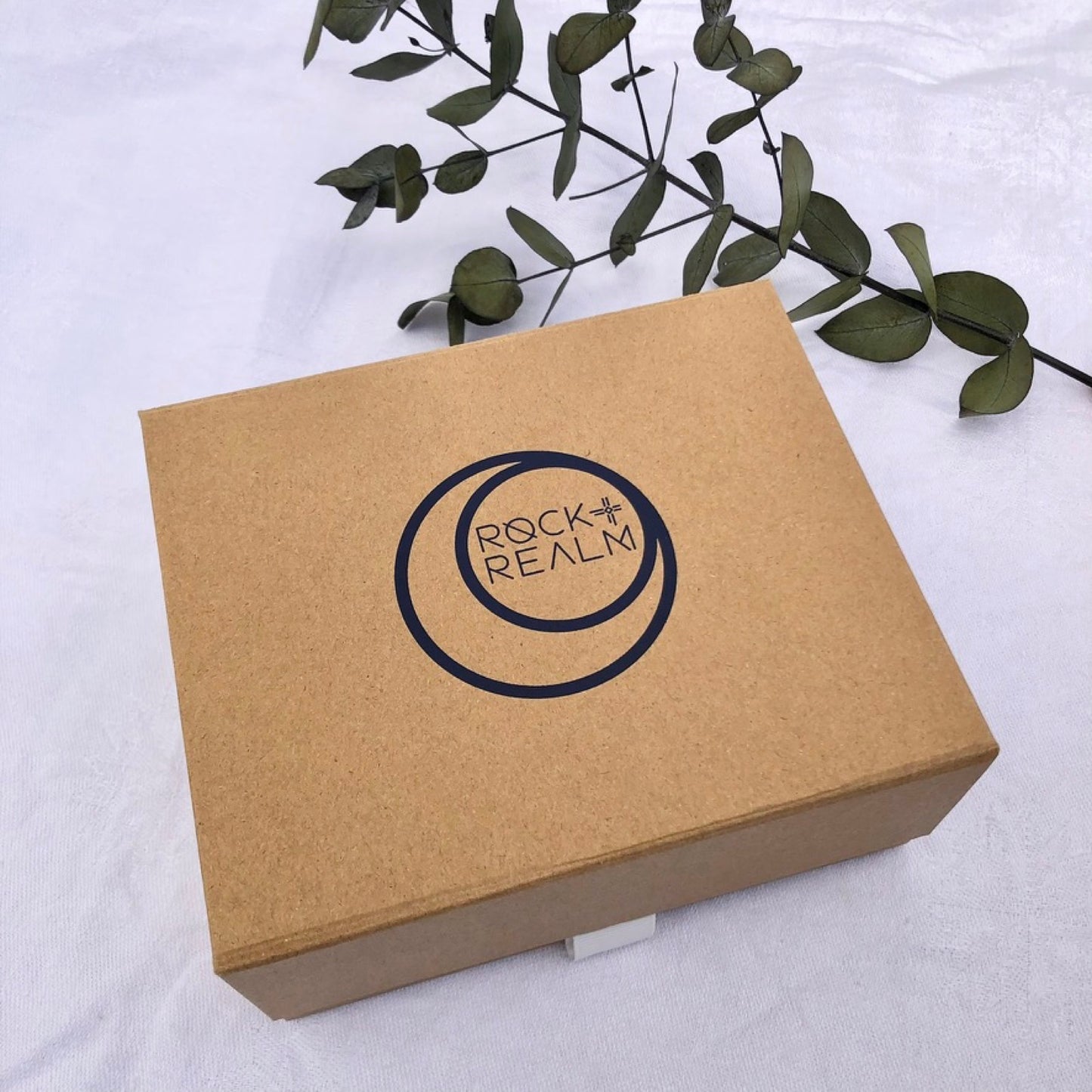 Craft brown recycled gift box branded with rock + realm in navy blue