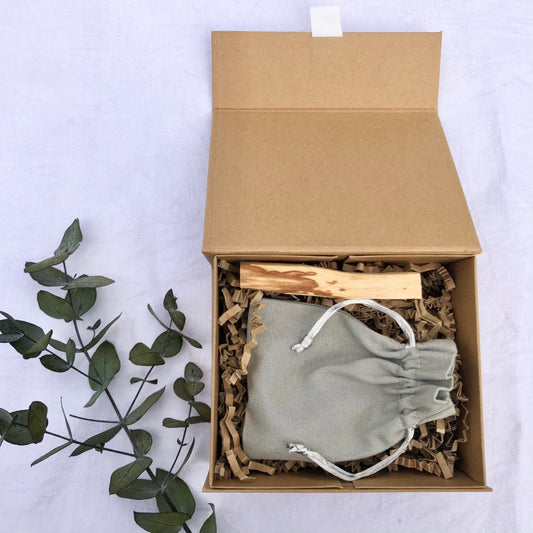 Craft brown recycled gift box filled with a cotton gift bag and Palo Santo