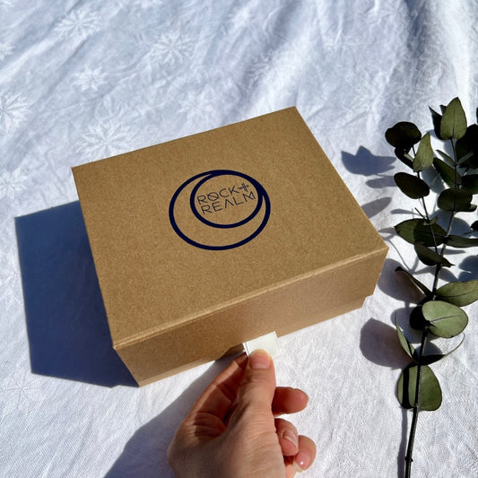 Craft brown recycled gift box branded with rock + realm in navy blue