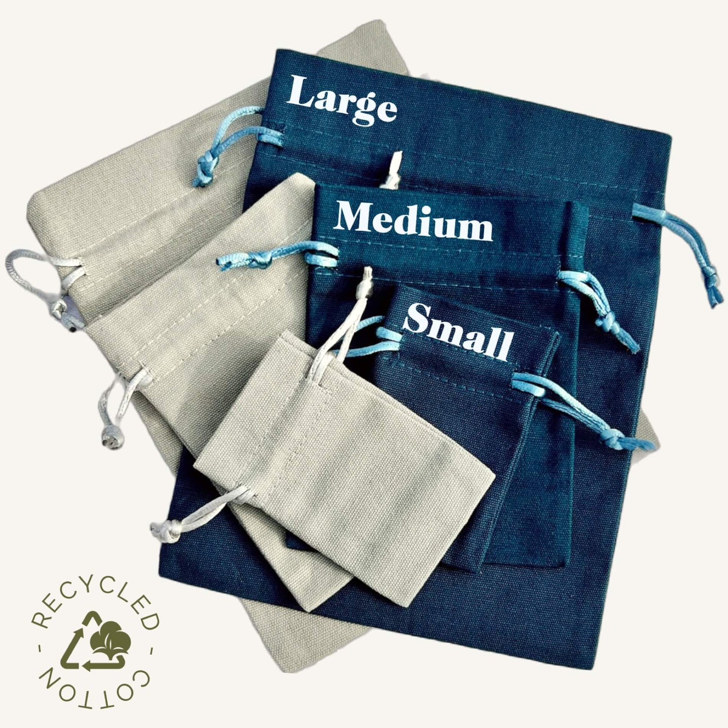A stack of grey and teal recycled cotton gift bags with size references