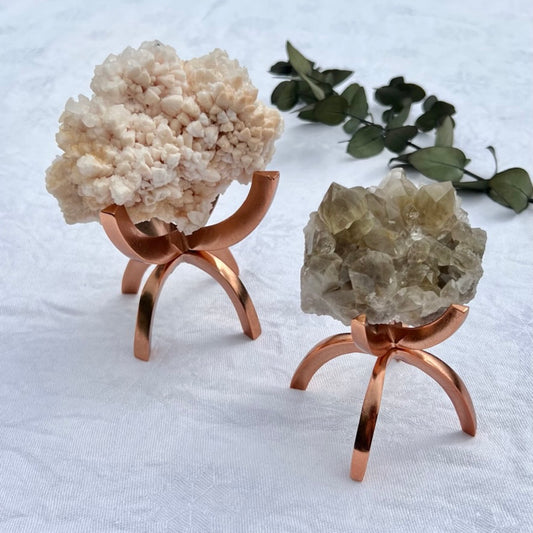 Large and small Rose gold crystal or mineral holders with crystal clusters in them 