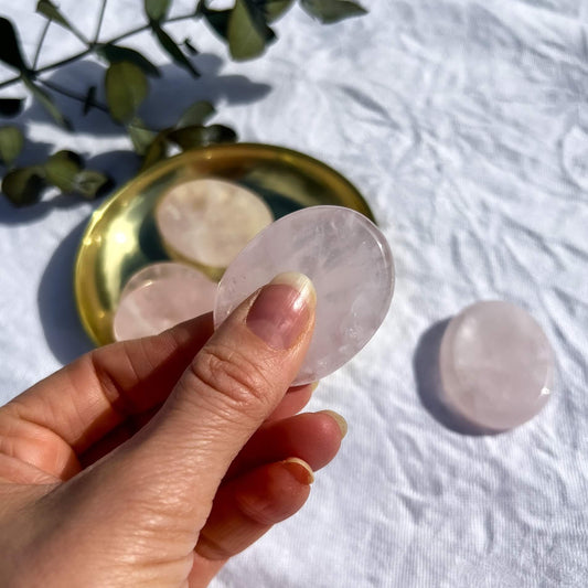 Pale pink gemmy rose quartz crystal oval worry stone rubbed between thumb and fingers