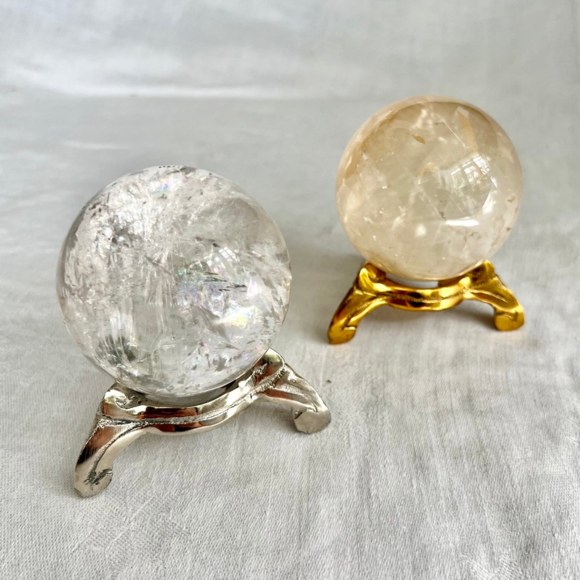 Vintage swirl style nickel and gold plated crystal sphere holders with crystal spheres on top