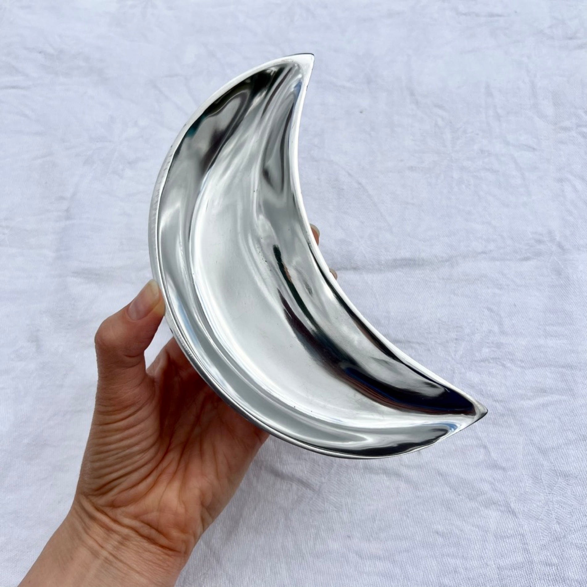 Silver moon bowl held to camera